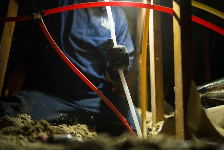 A technician cleaning a water line