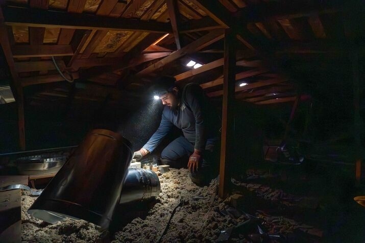 A technician inspecting an Air Duct