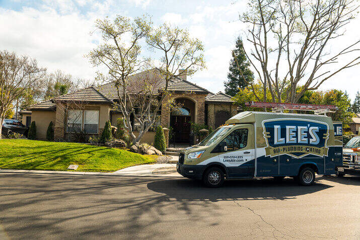 A home service van parked outside of a home