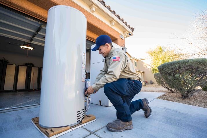 A technician installing a water heater