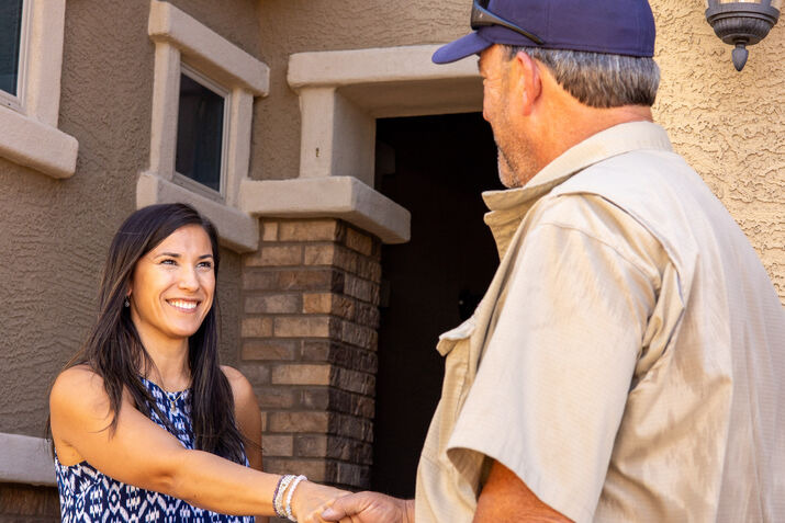 A technician shaking hands with a customer