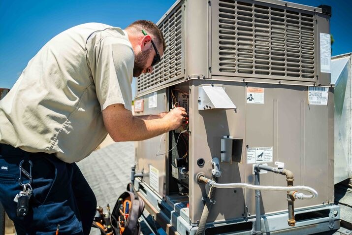 A technician repairing an Air Conditioner