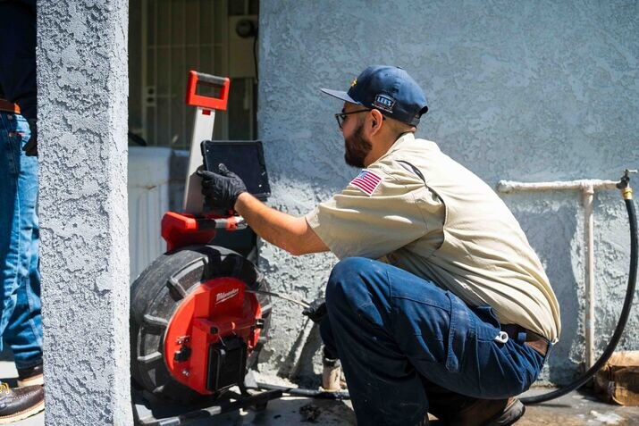 A technician inspecting a drain with a camera